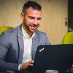 Uomo che lavora al computer e sorride